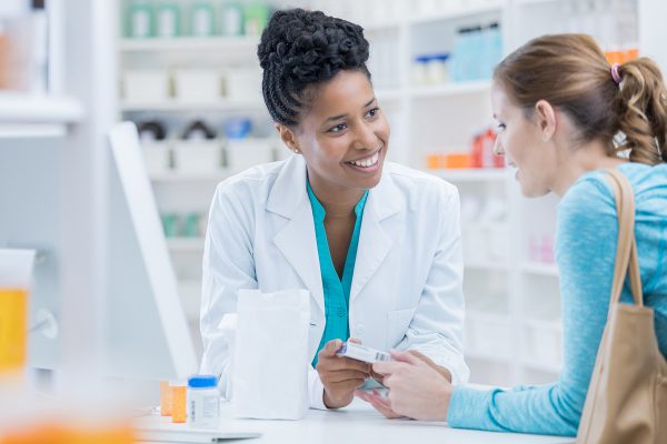 A friendly pharmacist talking with a customer